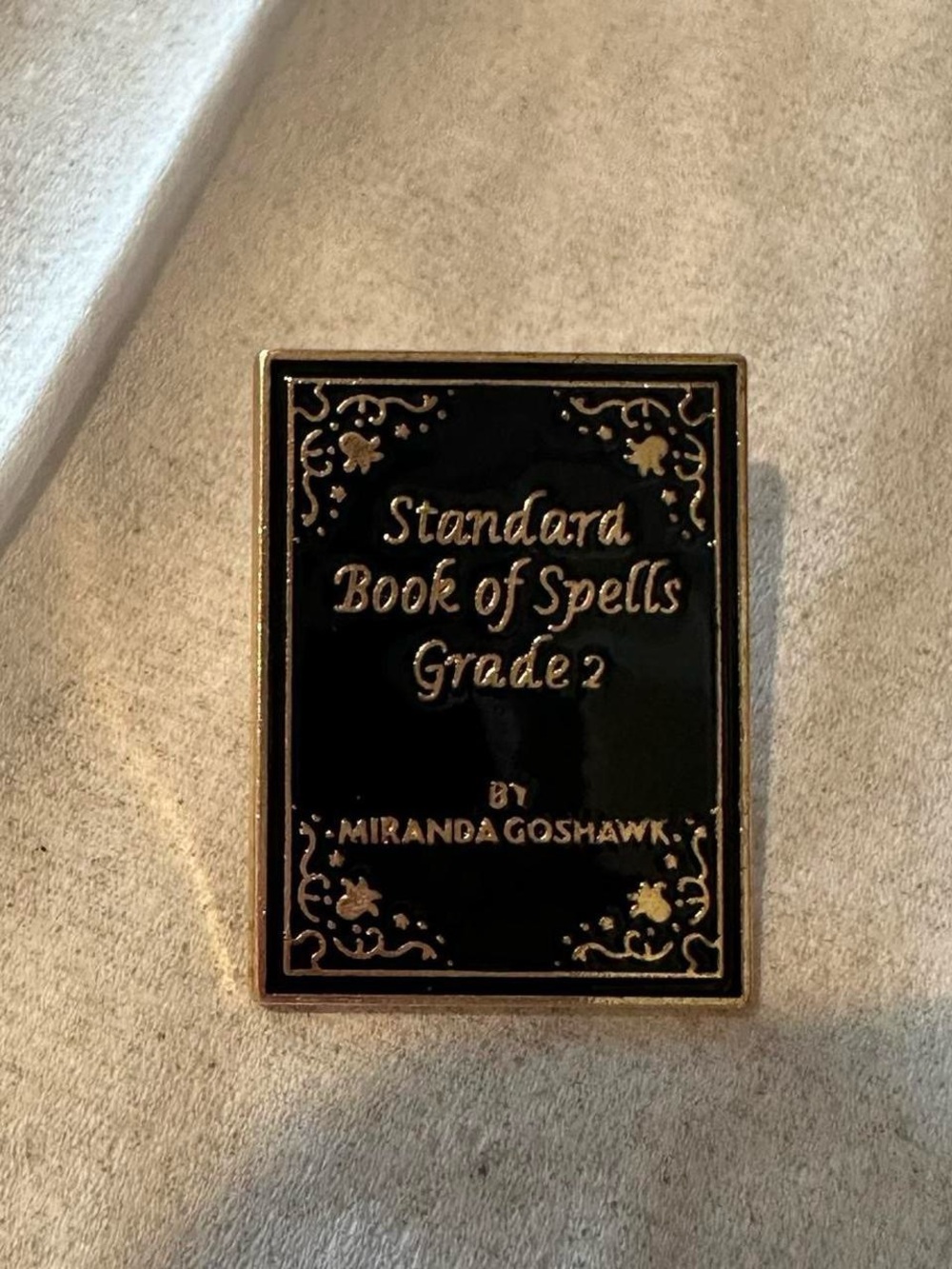 Harry Potter standard book of spells brooch pin.